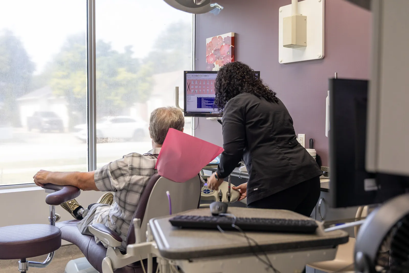 A dental hygienist caring for a patient at Amherstburg Dental