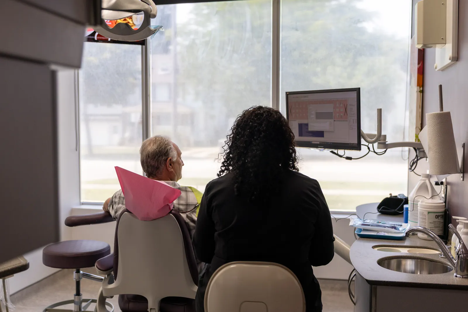 A team member reviewing care with a patient at Amherstburg Dental